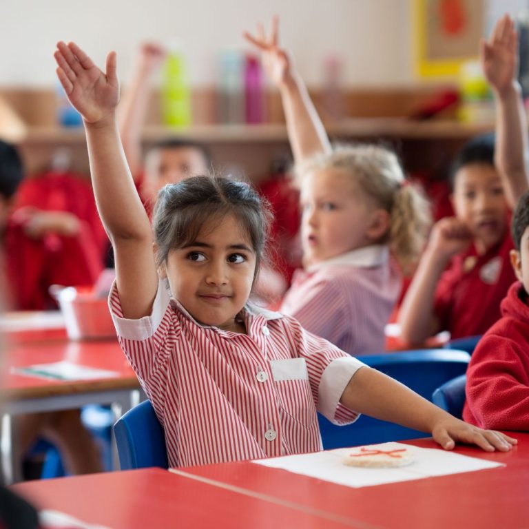 students with their hands up