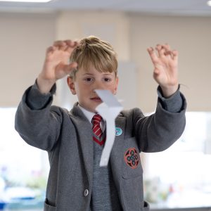 boy throwing paper
