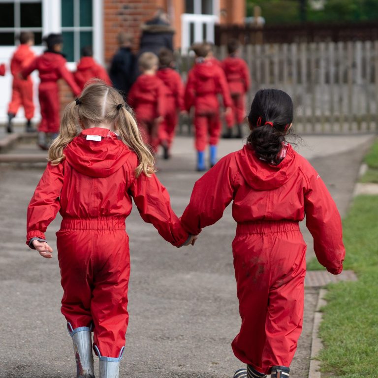 students walking hand in hand