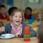 smiling child at lunchtime