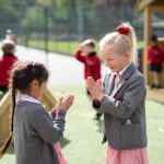 girls playing a clapping game