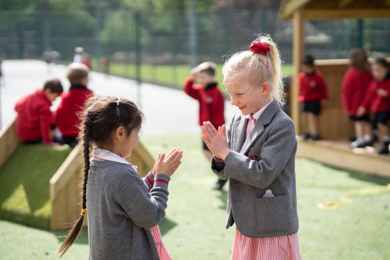 girls playing a clapping game