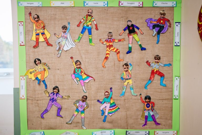 students in superhero figures