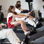 students using the rowing machine