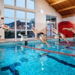 students diving into the swimming pool