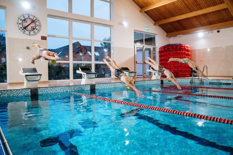 students diving into the swimming pool