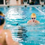 student swimming in the pool