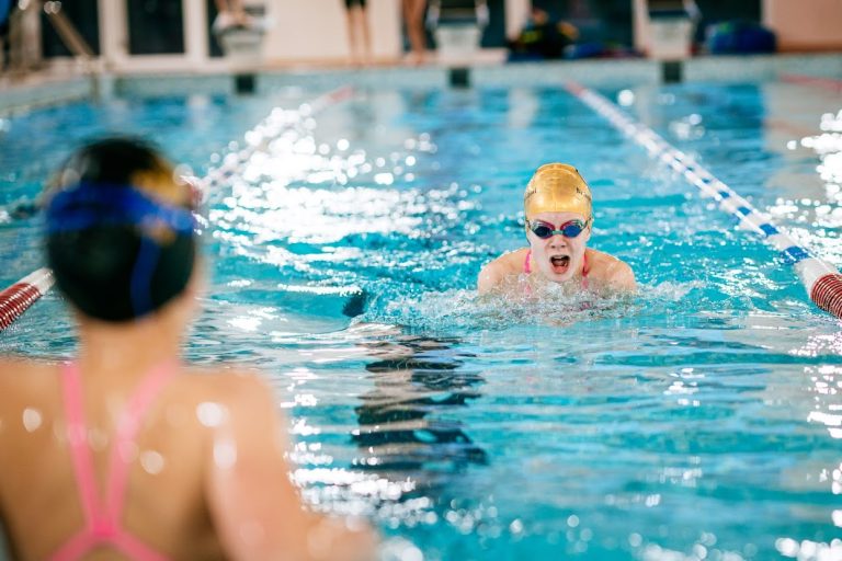 student swimming in the pool