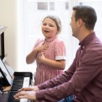 student singing with the piano being played by a teacher