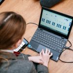 student using a laptop connected to a keyboard