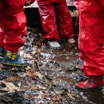 students wearing wellies, with puddles forming