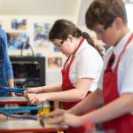 students using machines in a DT lesson