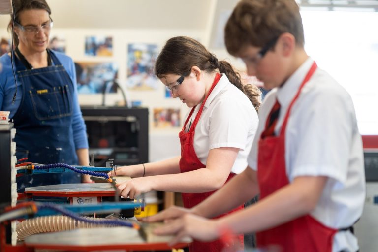 students using machines in a DT lesson