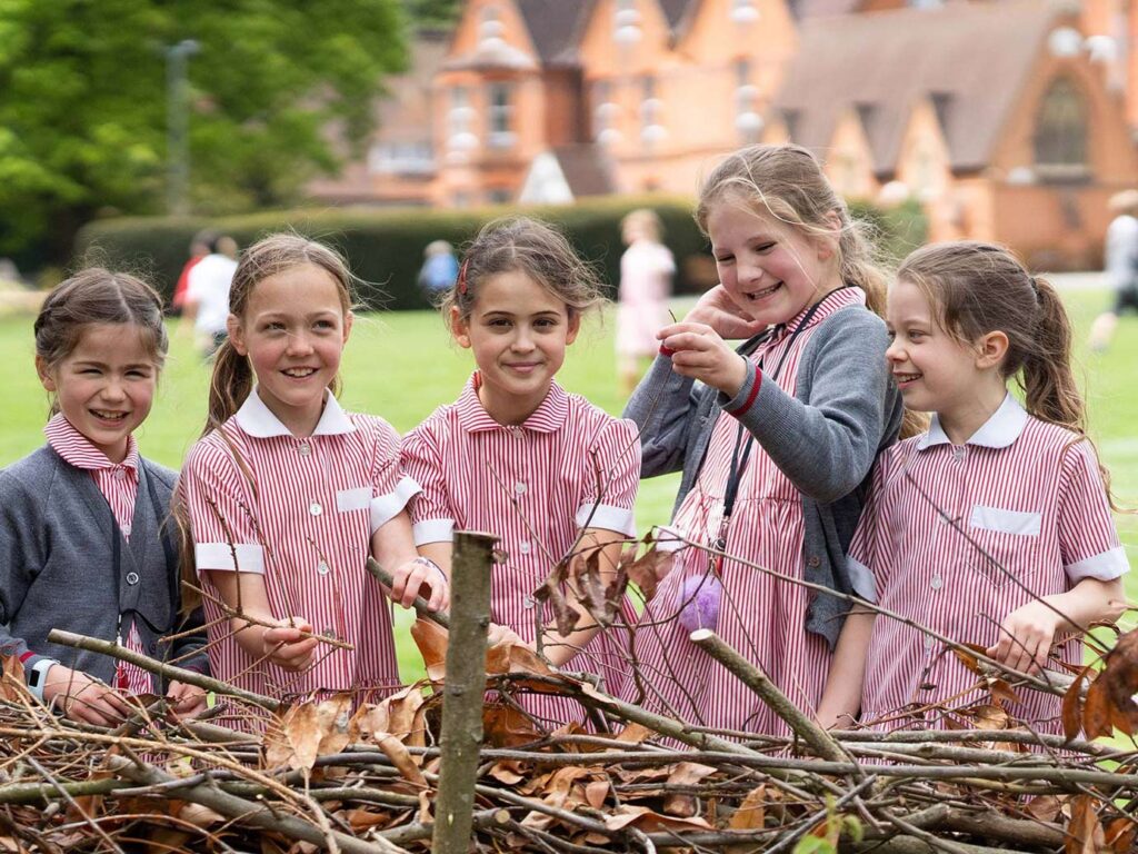 students holding twigs